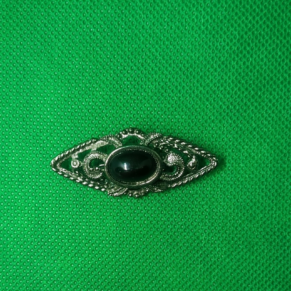 Silver and Black Brooch with Ornate Metalwork and Cabochon Stone